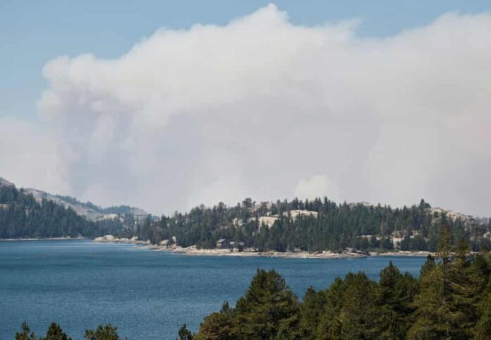 Smoke from the Caldor fire hovers over Caples Lake in Kirkwood, California.